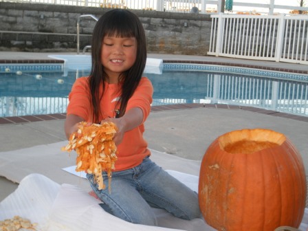 Kasen pulling out pumpkin goo